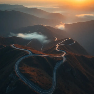 Aerial drone shot of winding mountain road at sunrise, mist in valleys, warm golden light, ultra-sharp focus, 8K drone photography